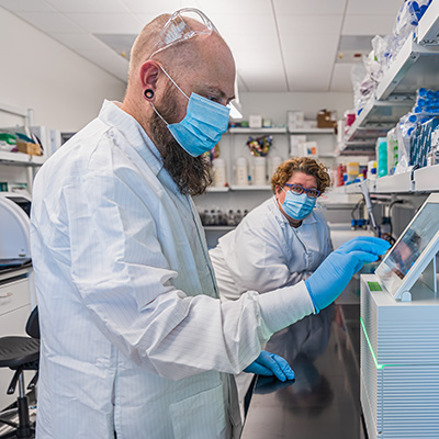 Professor Sistrom (left) and doctoral student Shari Larsen (right) in the lab.